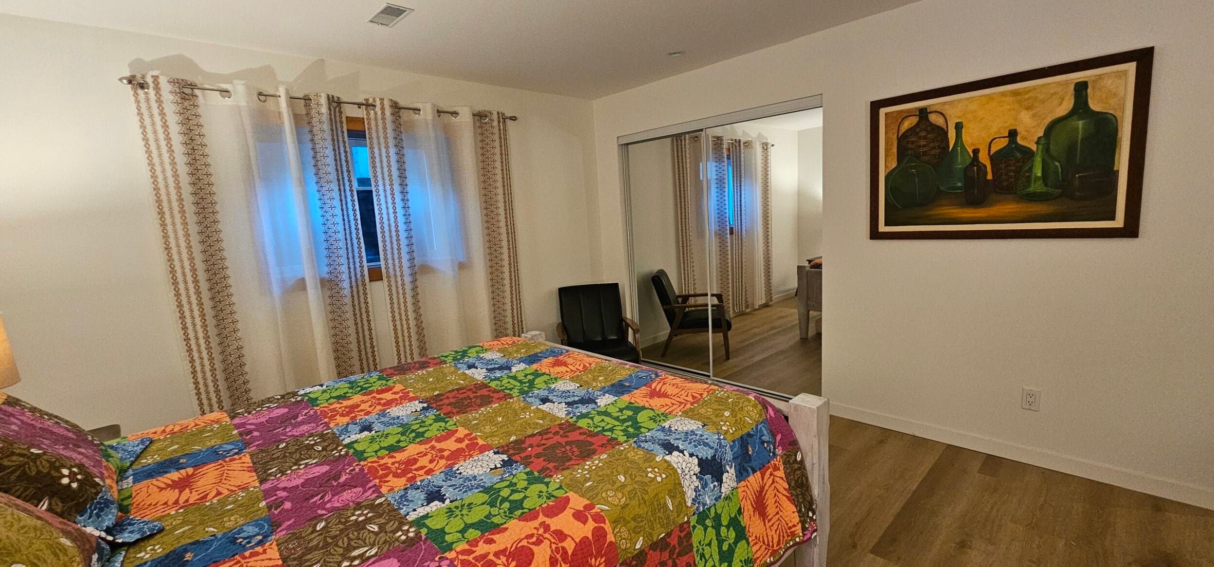 Bedroom with queen bed in vineyard vacation suite in Naramata BC