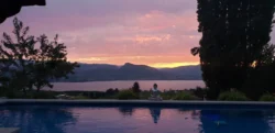 Pink sunset reflected in the pool overlooking Okanagan Lake